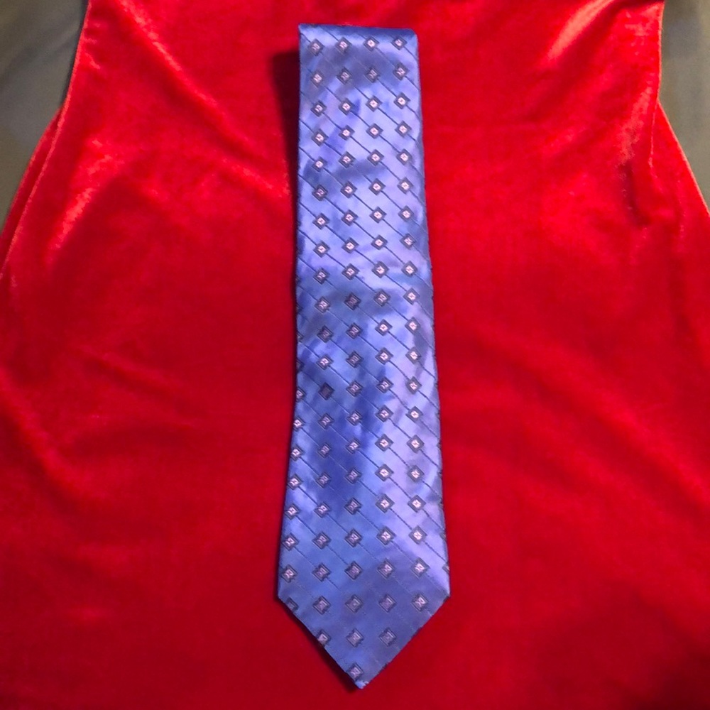 Blue tie with violet highlights. Measures about 3.75” at bottom.